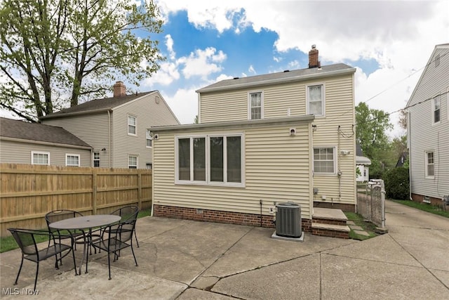 back of house with a patio, fence, central AC, outdoor dining area, and a chimney