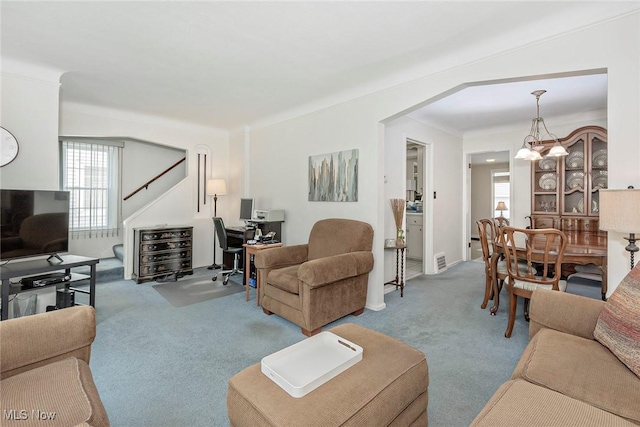 carpeted living room featuring an office area and stairway