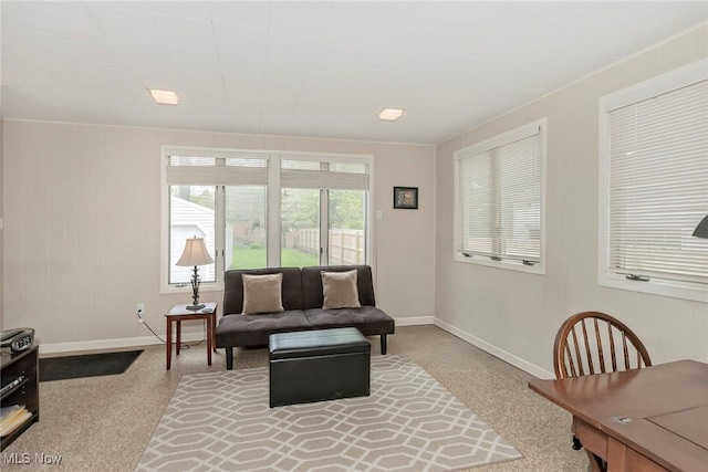 living room with baseboards and carpet