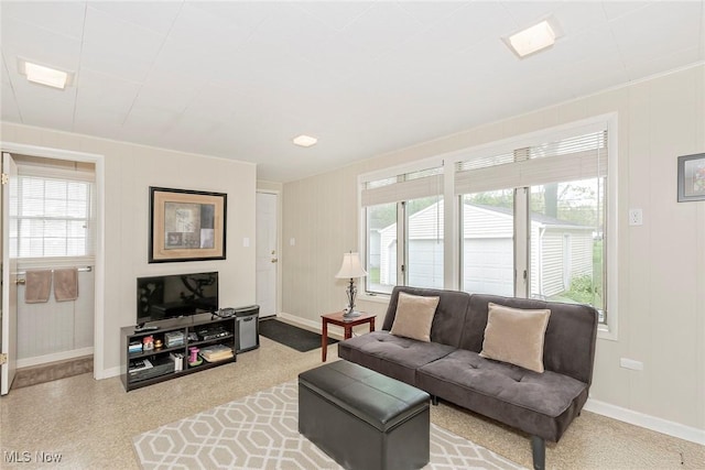 living room with baseboards and healthy amount of natural light
