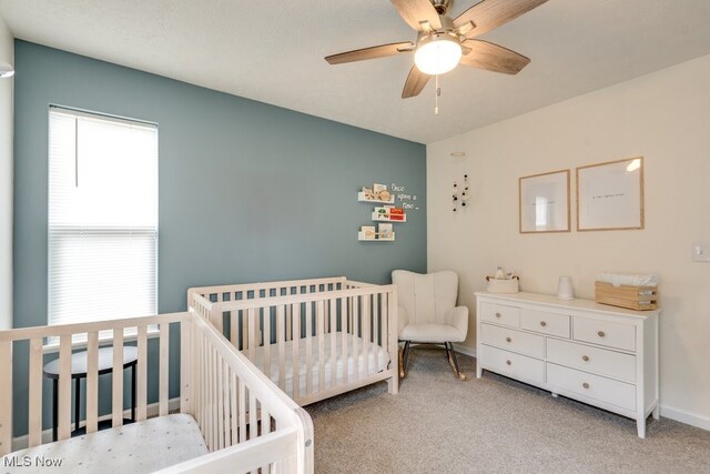 3585 Gerome Ct, Cleveland, OH 44105 - bedroom featuring light colored carpet, a ceiling fan, and a nursery area