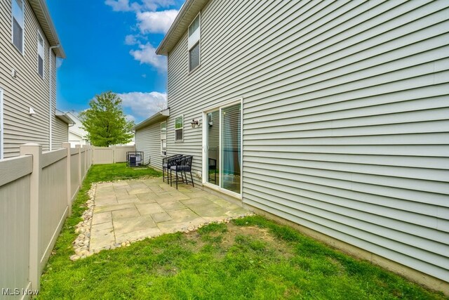3585 Gerome Ct, Cleveland, OH 44105 - fenced backyard with a patio area