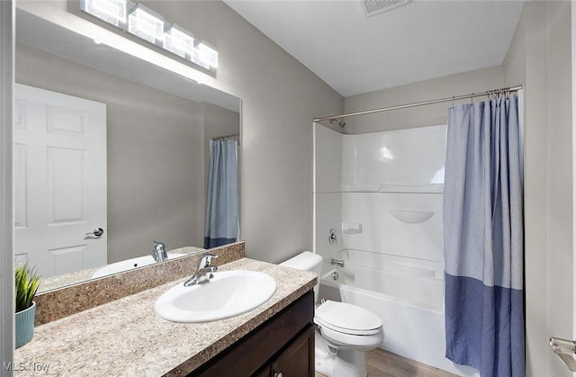 full bath with toilet, vanity, shower / bath combo with shower curtain, and wood finished floors