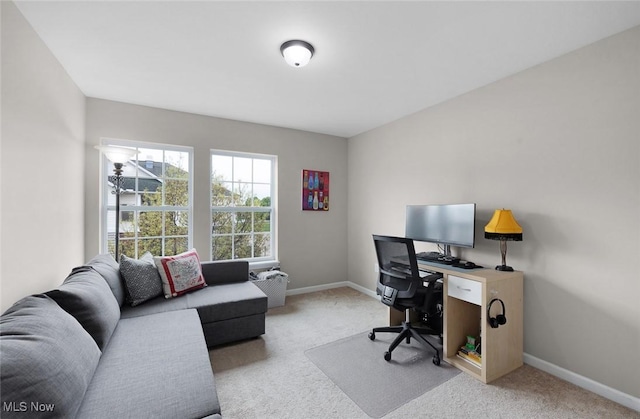 carpeted office space featuring baseboards