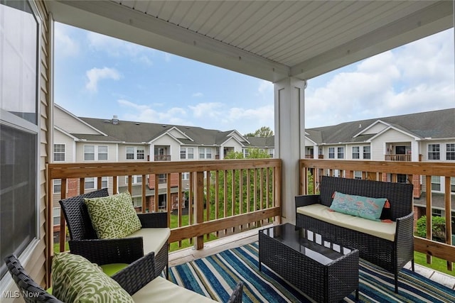 wooden deck featuring an outdoor living space and a residential view
