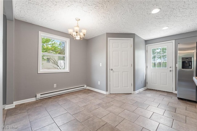 548 51st St SW, Canton, OH 44706 - unfurnished dining area with a baseboard heating unit, healthy amount of natural light, a chandelier, baseboards, and a textured ceiling