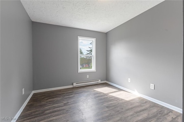 548 51st St SW, Canton, OH 44706 - spare room featuring a baseboard radiator, wood finished floors, a textured ceiling, and baseboards