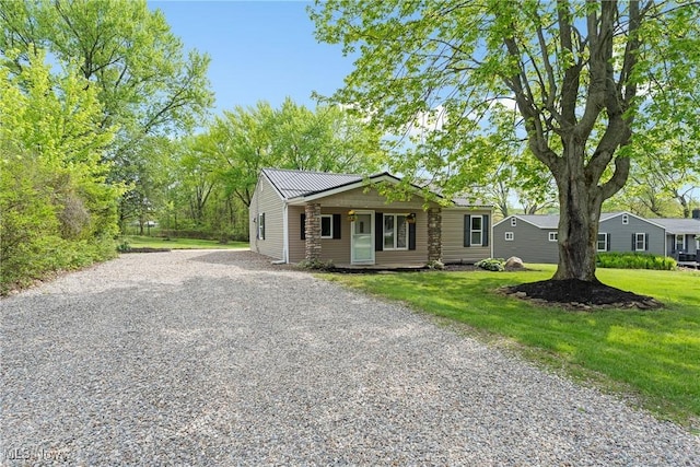 548 51st St SW, Canton, OH 44706 - view of front of home with driveway, a front lawn, and metal roof