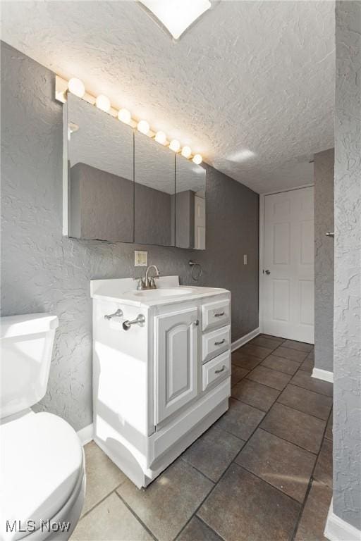 548 51st St SW, Canton, OH 44706 - bathroom featuring a textured wall, baseboards, a textured ceiling, toilet, and vanity