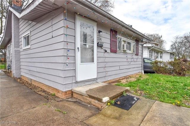 view of side of home with entry steps