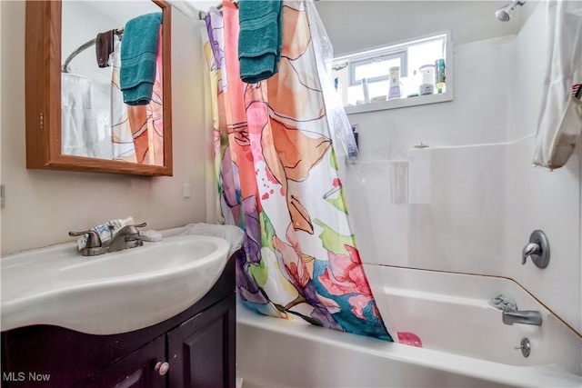 bathroom featuring shower / bath combo with shower curtain and vanity