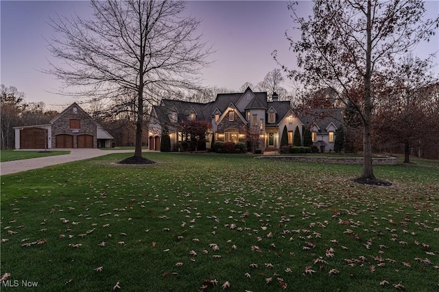 425 Woodside Ave, Jefferson, OH 44047 - french provincial home featuring stone siding, curved driveway, and a lawn