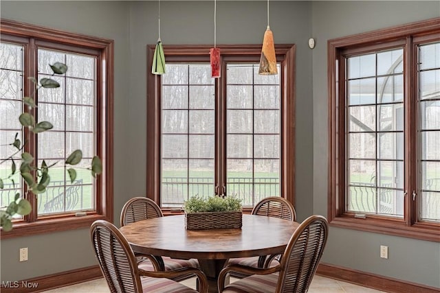 425 Woodside Ave, Jefferson, OH 44047 - dining area with baseboards, plenty of natural light, and light tile patterned flooring