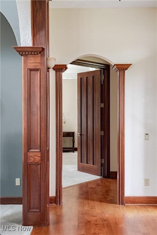 425 Woodside Ave, Jefferson, OH 44047 - hall featuring arched walkways, decorative columns, baseboards, and wood finished floors