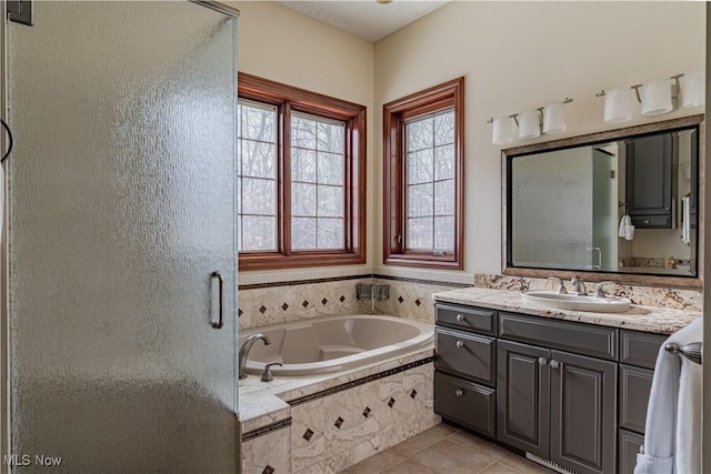 425 Woodside Ave, Jefferson, OH 44047 - bathroom with a garden tub, tile patterned floors, vanity, and a stall shower