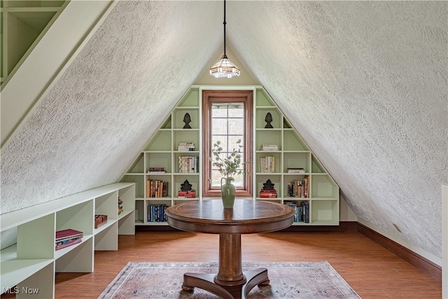 425 Woodside Ave, Jefferson, OH 44047 - additional living space featuring built in features, wood finished floors, lofted ceiling, and baseboards