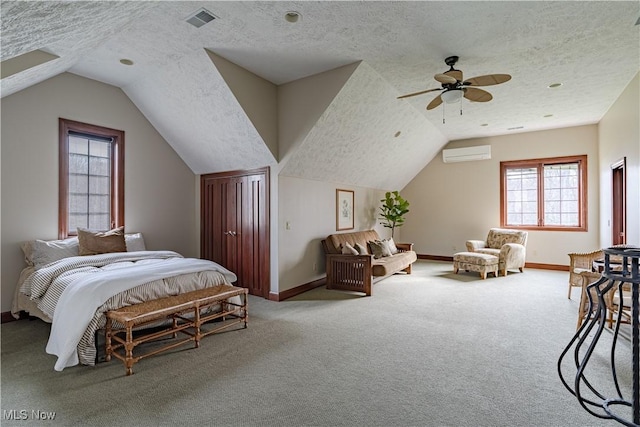 425 Woodside Ave, Jefferson, OH 44047 - carpeted bedroom featuring a wall mounted AC, a textured ceiling, lofted ceiling, baseboards, and a ceiling fan