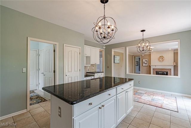 3020 Irena Ln, Twinsburg, OH 44087 - kitchen with a chandelier, light tile patterned floors, white cabinets, and baseboards