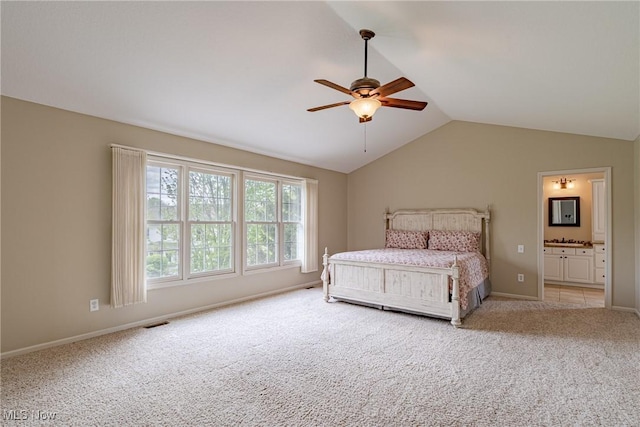3020 Irena Ln, Twinsburg, OH 44087 - bedroom with carpet flooring, vaulted ceiling, a ceiling fan, baseboards, and connected bathroom