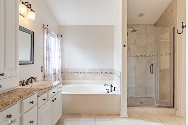 3020 Irena Ln, Twinsburg, OH 44087 - full bathroom featuring a shower stall, vanity, a garden tub, tile patterned flooring, and vaulted ceiling