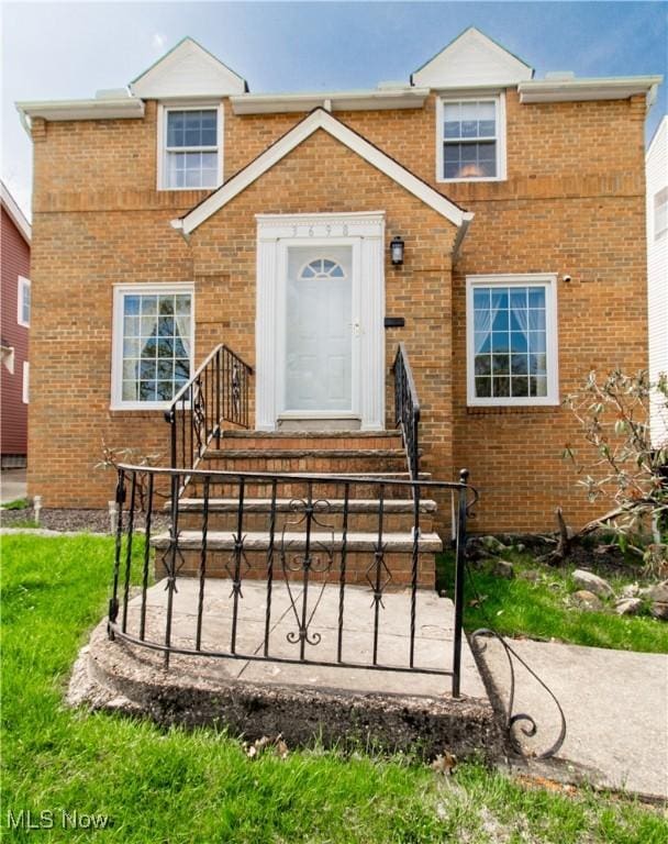 view of front of property with brick siding and a fenced front yard