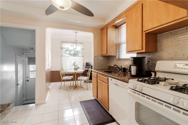 kitchen featuring white appliances, a sink, decorative backsplash, ceiling fan, and light tile patterned floors