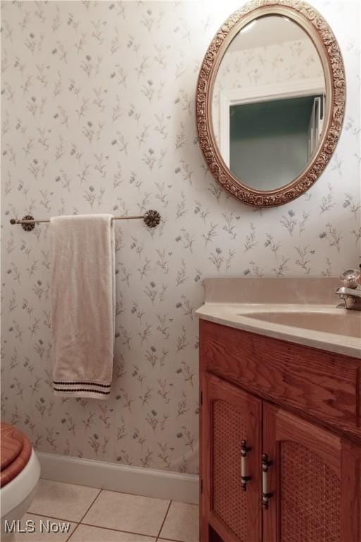 bathroom with vanity, tile patterned flooring, toilet, and baseboards