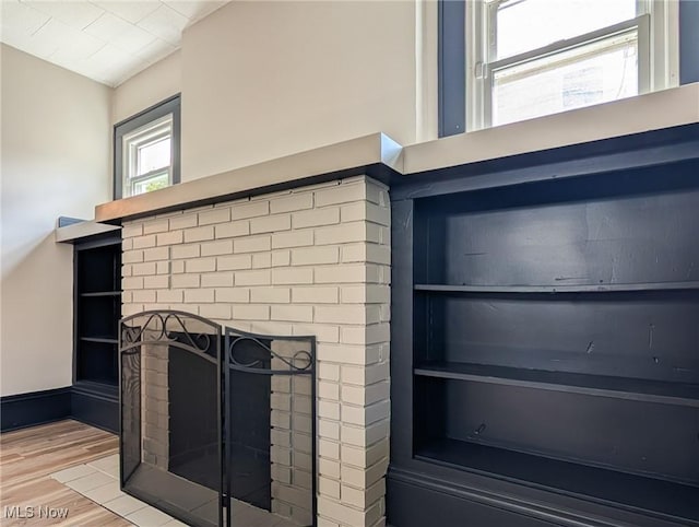 detailed view of wood finished floors and a fireplace