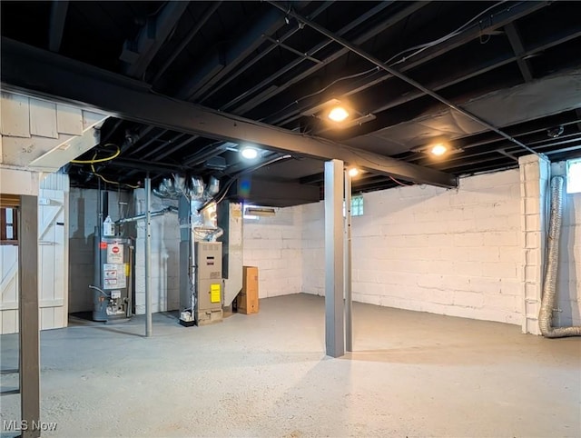 basement with water heater and heating unit