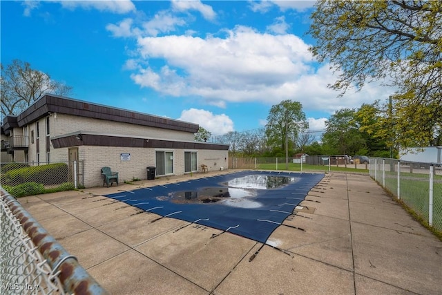 view of pool with fence and a patio area