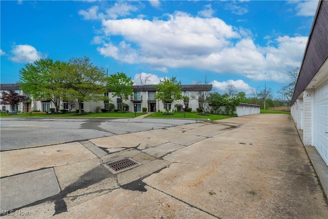 view of asphalt road with a residential view
