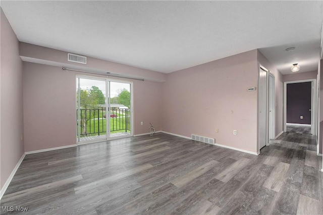 empty room with wood finished floors and baseboards