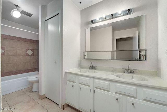 bathroom featuring tile patterned flooring, toilet, double vanity, and shower / bath combination