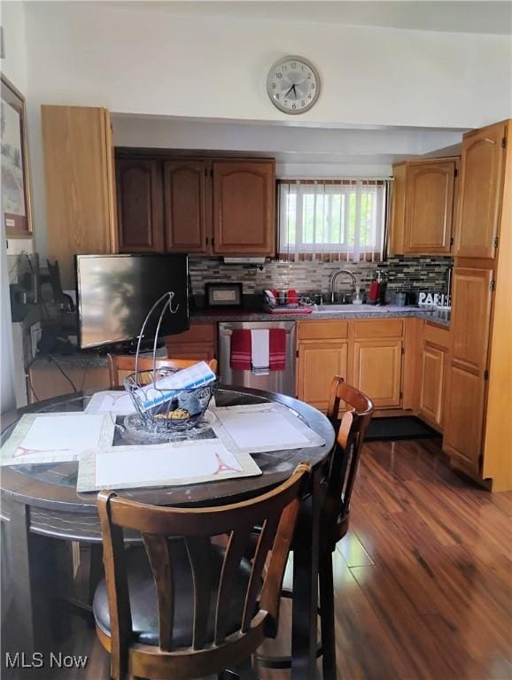13418 Coath Ave, Cleveland, OH 44120 - kitchen featuring dishwasher, a sink, dark wood-style floors, and backsplash