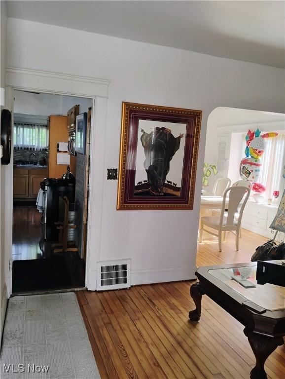 13418 Coath Ave, Cleveland, OH 44120 - hallway featuring wood finished floors, baseboards, and a sink