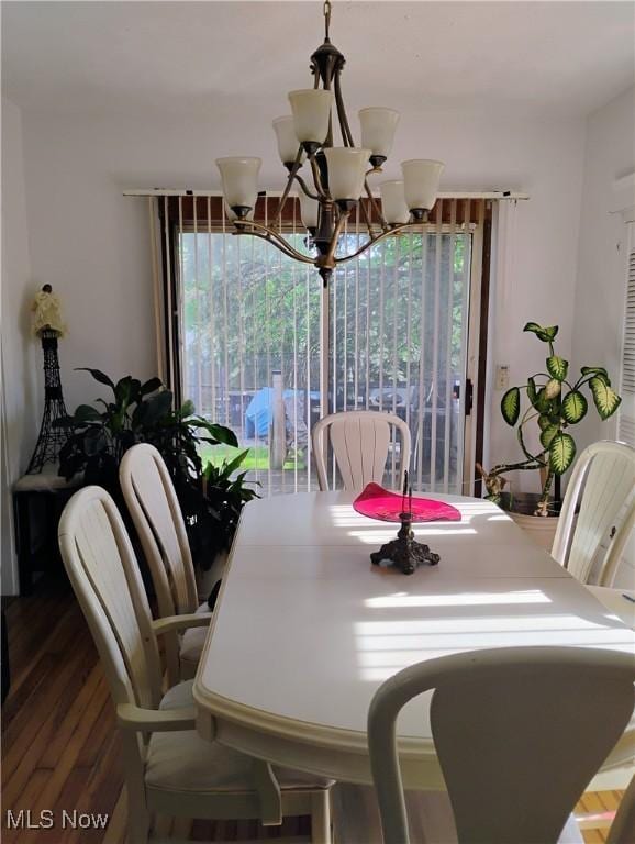 13418 Coath Ave, Cleveland, OH 44120 - dining area featuring a chandelier, healthy amount of natural light, and wood finished floors