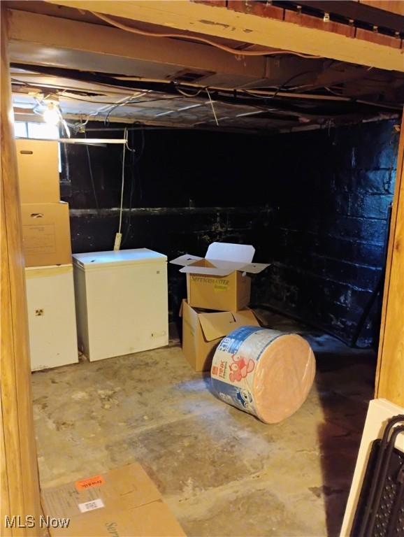 13418 Coath Ave, Cleveland, OH 44120 - unfinished below grade area with refrigerator