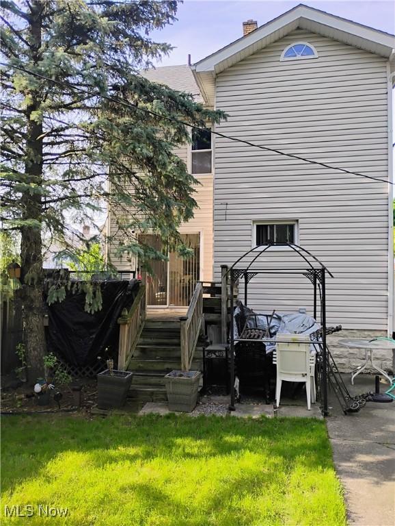13418 Coath Ave, Cleveland, OH 44120 - back of property featuring a chimney and a yard