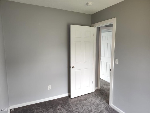 unfurnished bedroom with carpet and baseboards