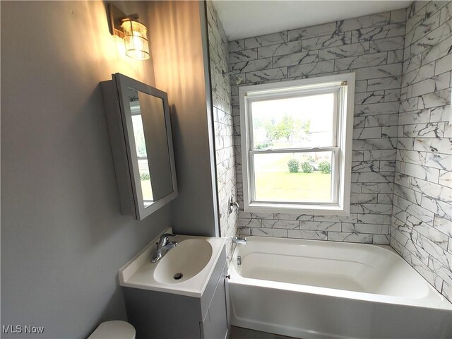 full bathroom with a tub and vanity