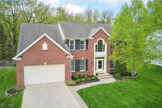 1284 Spafford Dr, Copley, OH 44321 - colonial house with driveway, a garage, a front yard, brick siding, and a shingled roof
