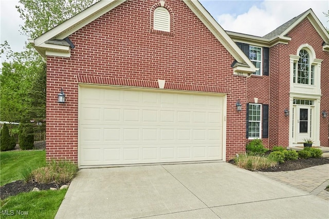 1284 Spafford Dr, Copley, OH 44321 - view of property exterior featuring concrete driveway, brick siding, and a garage