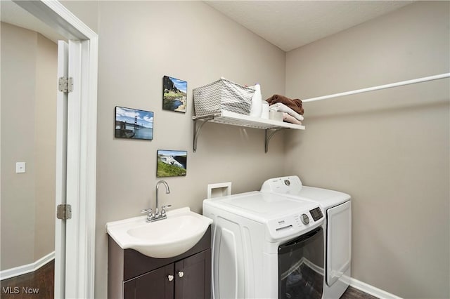 1284 Spafford Dr, Copley, OH 44321 - laundry room featuring washer and dryer, cabinet space, baseboards, and dark wood-style flooring