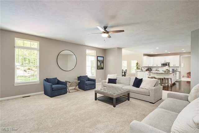 1284 Spafford Dr, Copley, OH 44321 - living area with plenty of natural light, ceiling fan, baseboards, recessed lighting, and a textured ceiling
