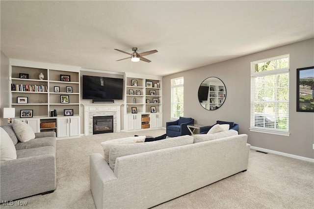 1284 Spafford Dr, Copley, OH 44321 - living area featuring plenty of natural light, a ceiling fan, baseboards, and a glass covered fireplace