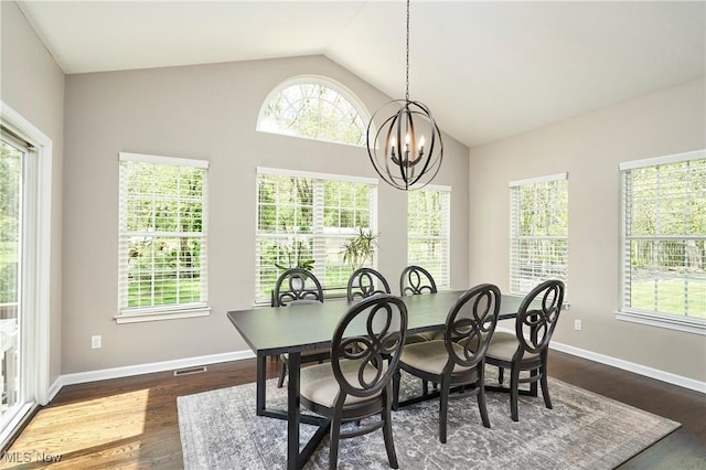1284 Spafford Dr, Copley, OH 44321 - dining room featuring a chandelier, vaulted ceiling, dark wood-type flooring, and baseboards