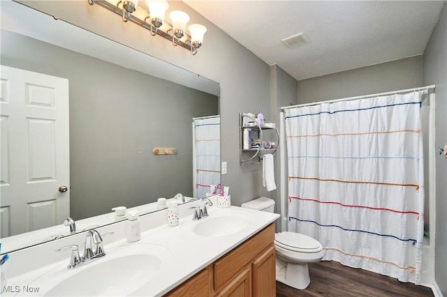 1284 Spafford Dr, Copley, OH 44321 - bathroom featuring toilet, wood finished floors, curtained shower, and double vanity
