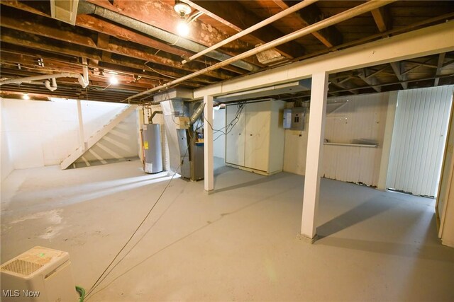 unfinished basement featuring water heater, stairs, heating unit, and electric panel