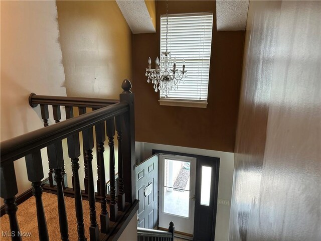 stairs with a textured ceiling