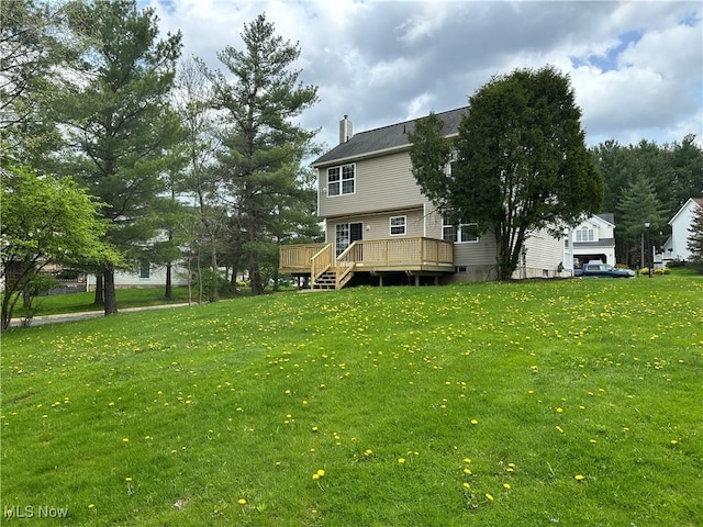 view of grassy yard featuring a wooden deck